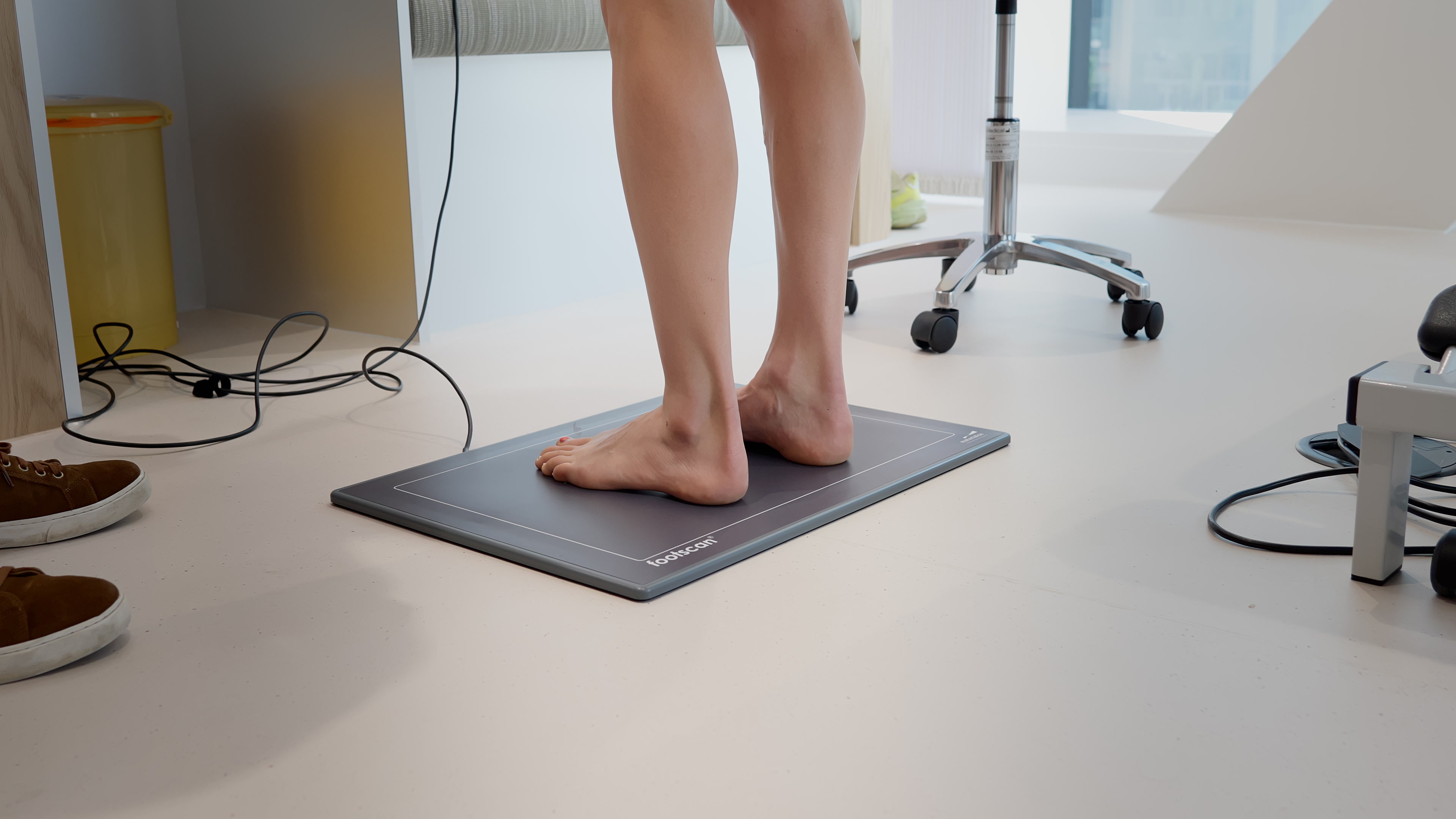 Patient standing on a pressure mat during biomechanical assessment